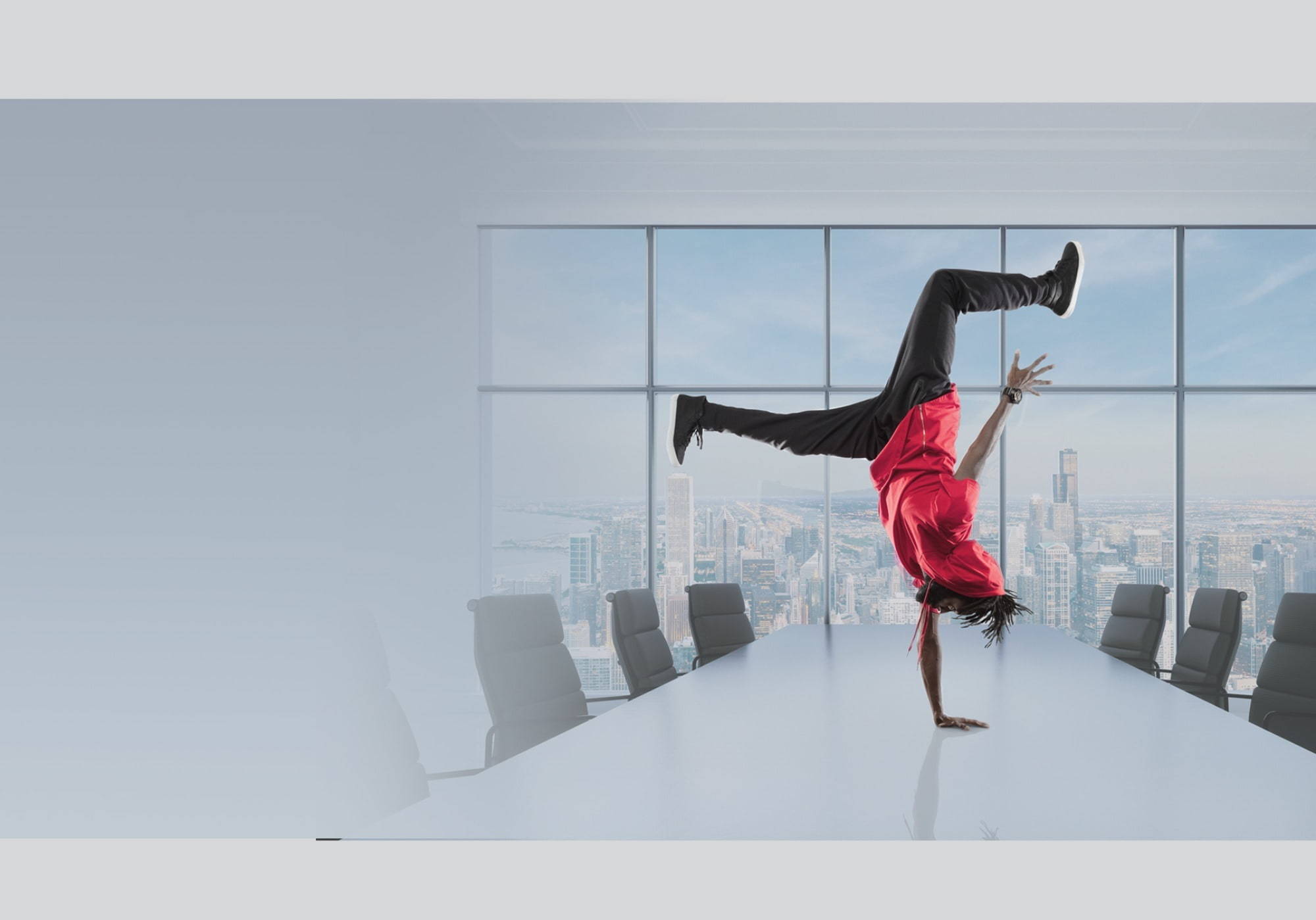 A man doing a handstand at an office table | Employment Agencies